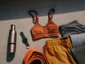 Athleisure clothing and accessories arranged for fitness or yoga.