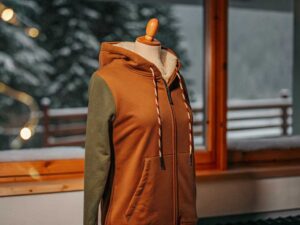 Two-tone brown and green fleece hoodie on mannequin, with thick drawstrings and cozy lining.