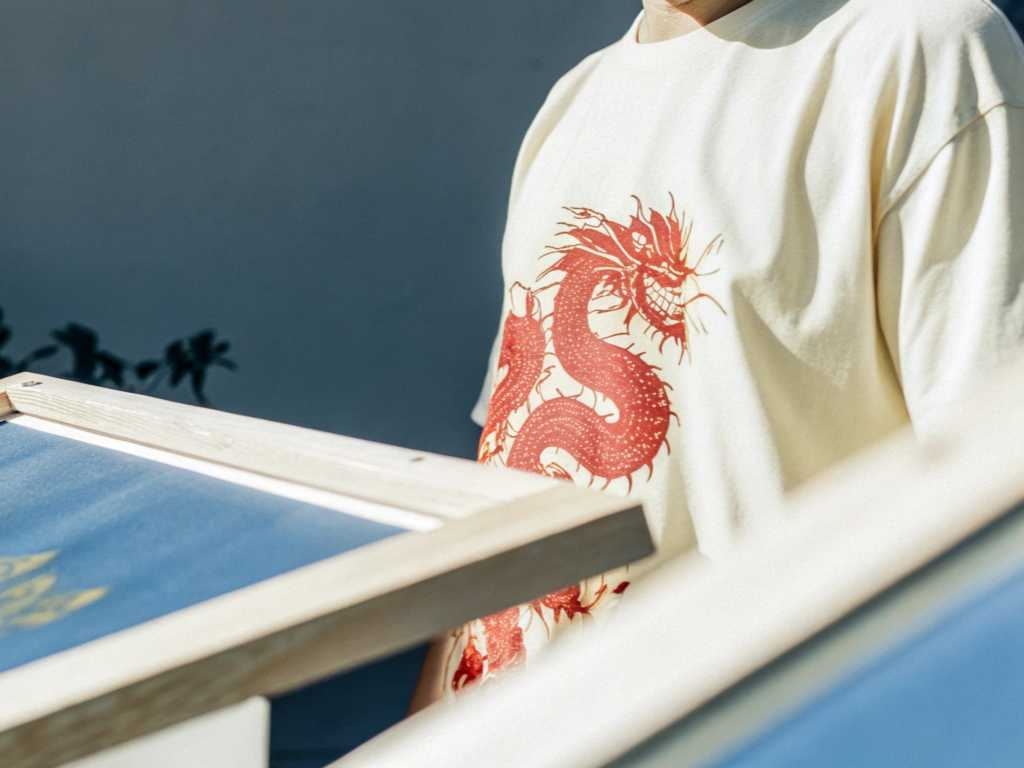 Close-up of white T-shirt with red dragon screen print