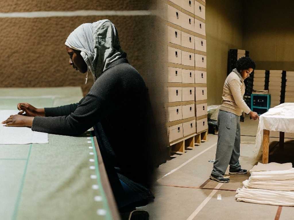 Workers cutting fabric and stacking blanks in garment facility