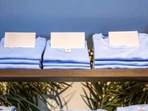 Stacks of light blue T-shirts with blank price cards