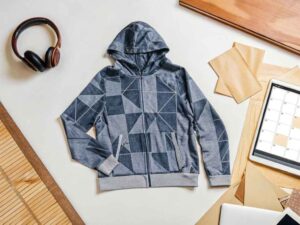 Geometric printed hoodie flat lay with planner and tools
