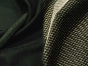 Close-up showing smooth knit versus waffle weave dark green fabric