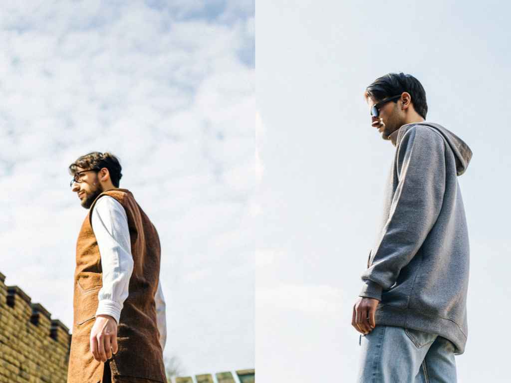 Two men in brown vest and grey hoodie against sky