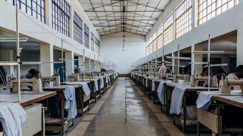 Sewing machines lined up in garment production factory