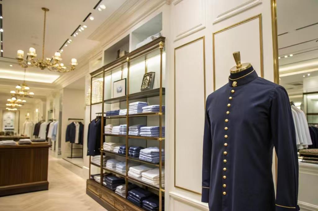 Elegant navy uniform on mannequin in upscale store.