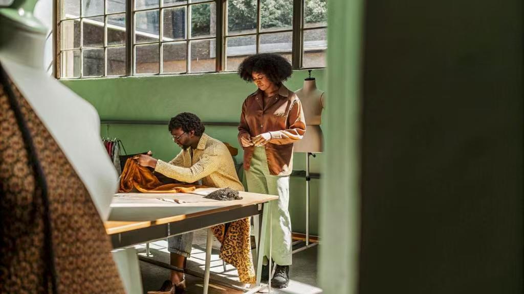 Two designers collaborating in bright garment studio